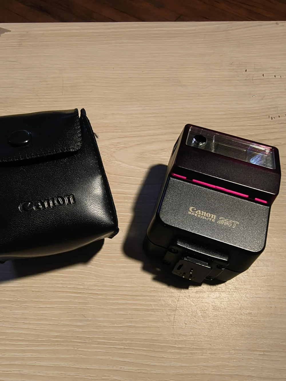 vintage Canon Speedlite 244T electronic flash unit with its leather case,